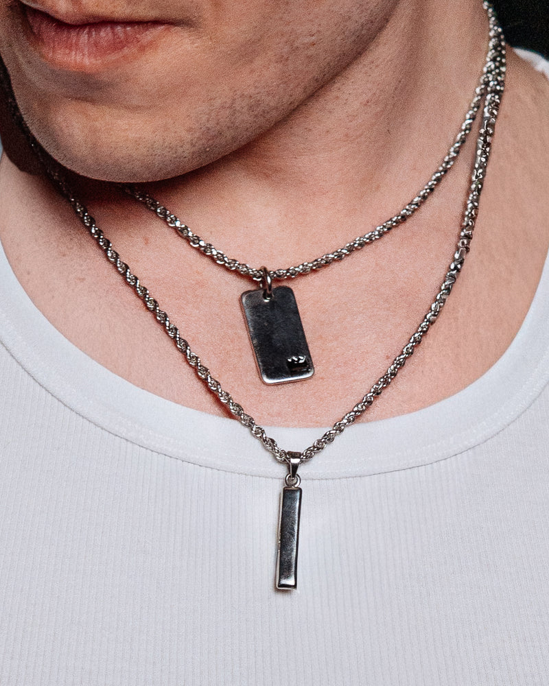 Rope Chain 3mm - styled with Totem Pendant, Crown Dog Tag, St Christopher Pendant, Cuban Chain 5mm and Rope Chain 3mm, pendants and chains styled together on dark wood surface