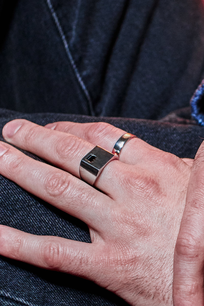 Crown Signet Ring - styled with Plain Band Ring, hand resting on dark denim jacket