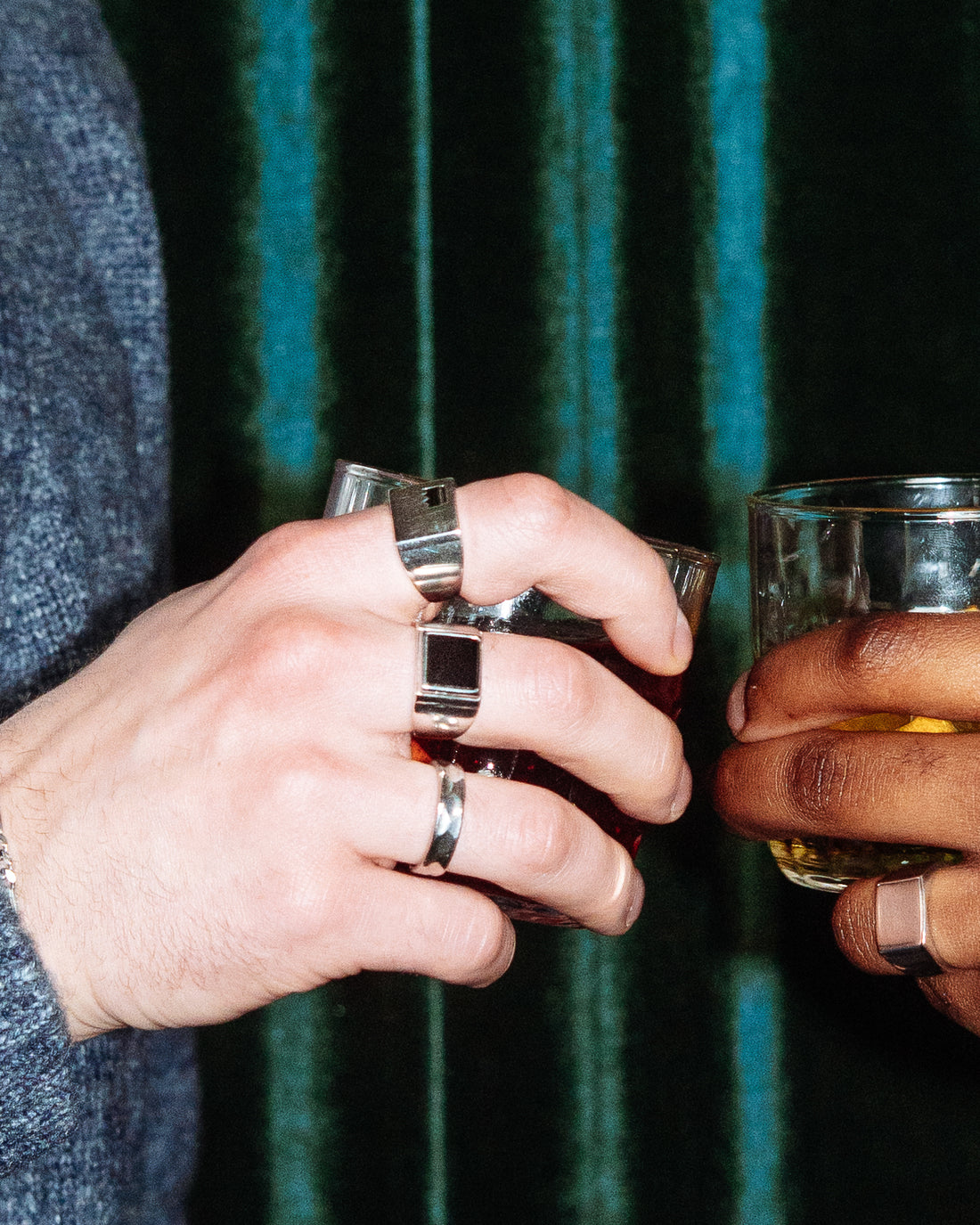 Crown Signet Ring - stacked with Plain Signet Ring, Onyx Signet Ring and Hammered Band Ring, two hands toasting with cocktails