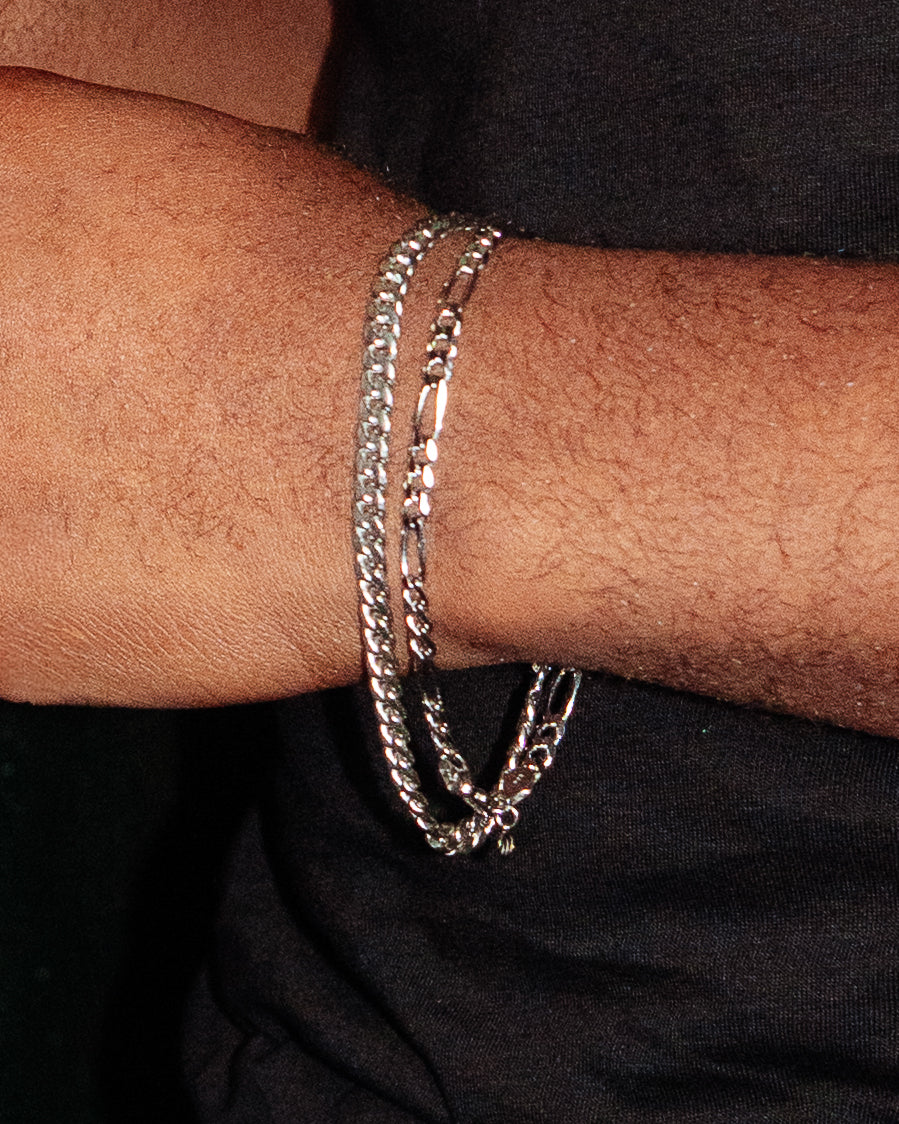 Figaro Bracelet 5mm - styled with Crown Signet Ring, Onyx Signet Ring and Hammered Band Ring, two hands close-up holding cocktail glasses