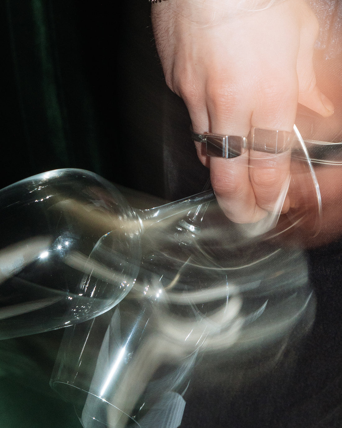 Onyx Signet Ring - styled with Hammered Band Ring, hand reaching for glassware in editorial motion shot
