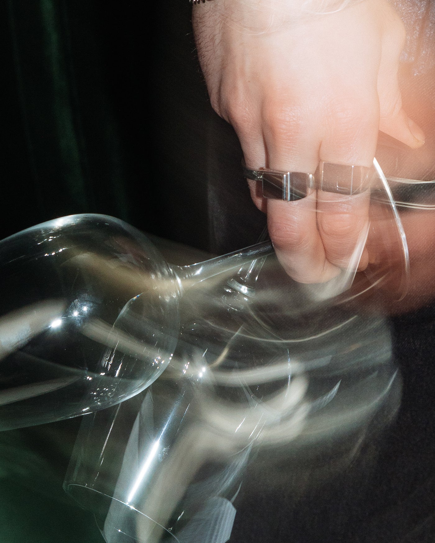 Onyx Signet Ring - styled with Hammered Band Ring, hand reaching for glassware in editorial motion shot