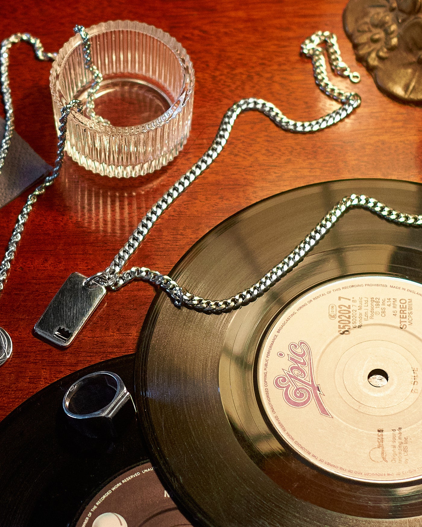 Cuban Chain 5mm - styled with Cuban Chain 5mm, Vitruvian Pendant, Crown Dog Tag, Plain Band Ring and Onyx Signet Ring, tabletop arrangement