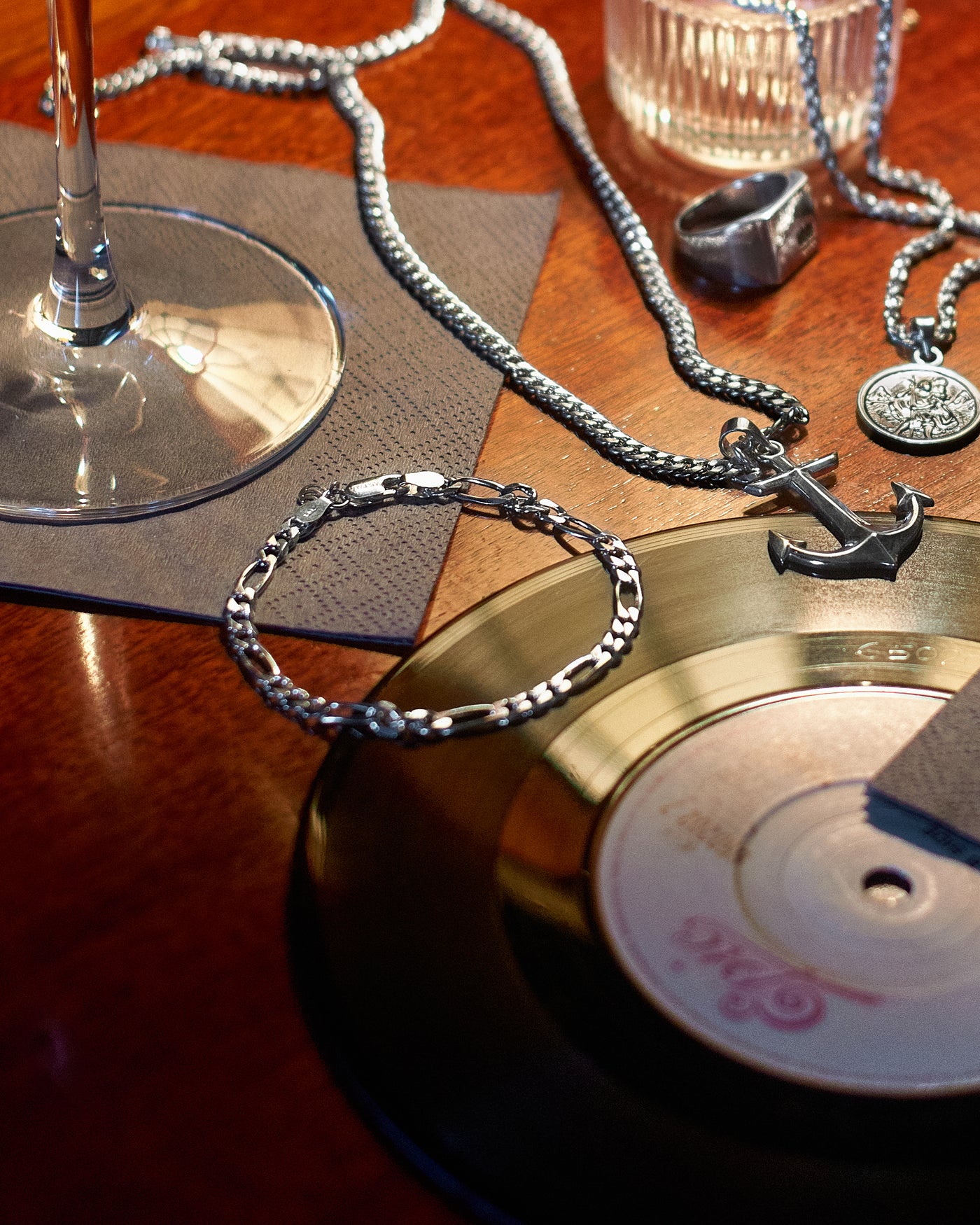 Figaro Bracelet 5mm - styled with Anchor Pendant, St Christopher Pendant, Hammered Band Ring, Figaro Bracelet 5mm, Cuban Chain 5mm, Rope Chain 3mm and Crown Signet Ring, layered jewellery group shot