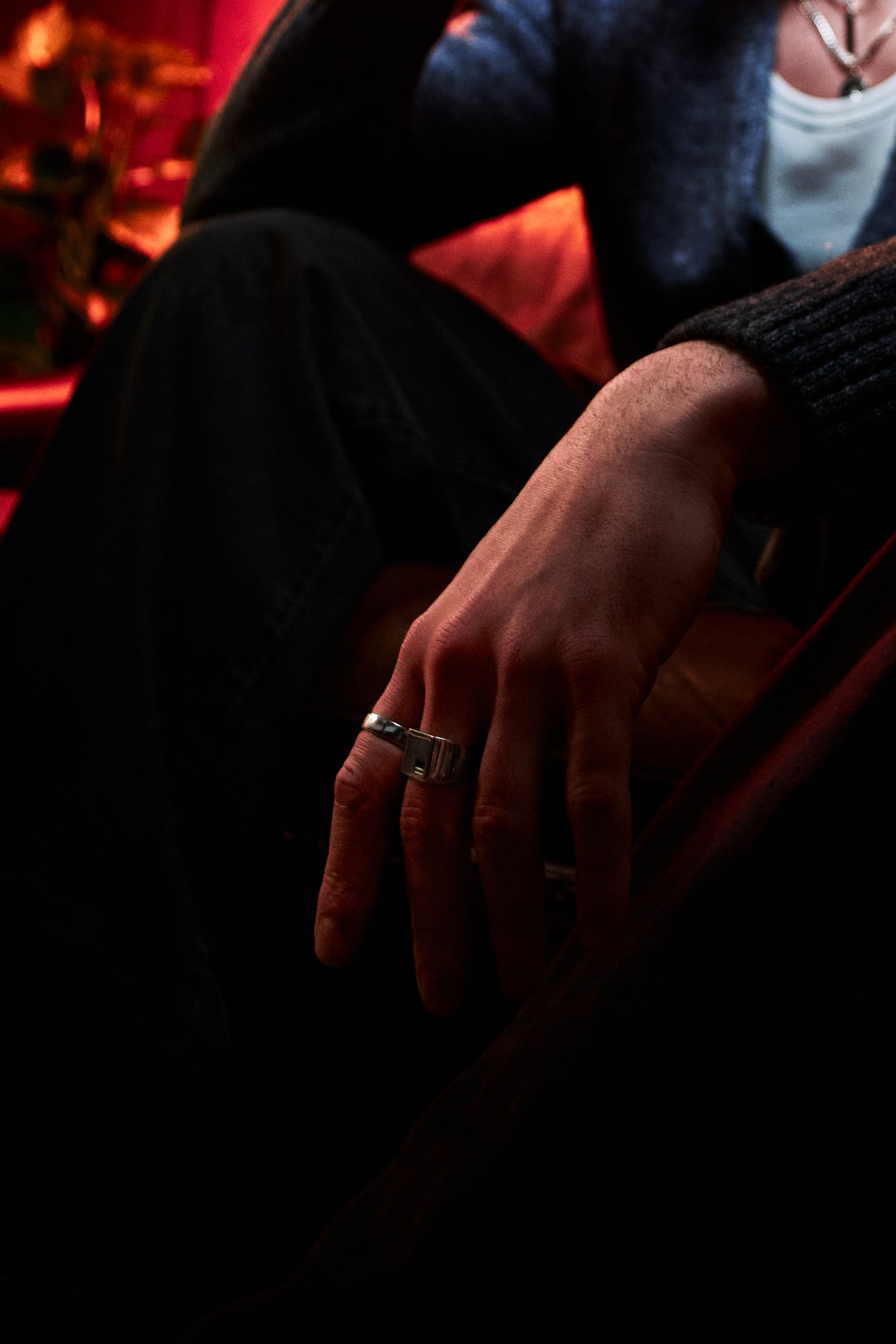 Crown Signet Ring - single ring on hand at rest, low-light editorial setting