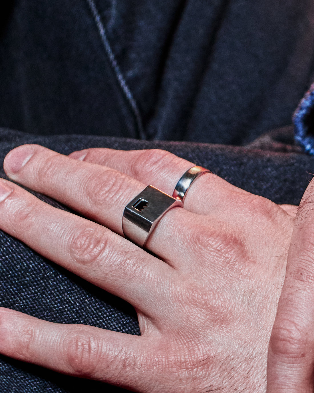 Crown Signet Ring - styled with Plain Band Ring, hand resting on dark denim jacket